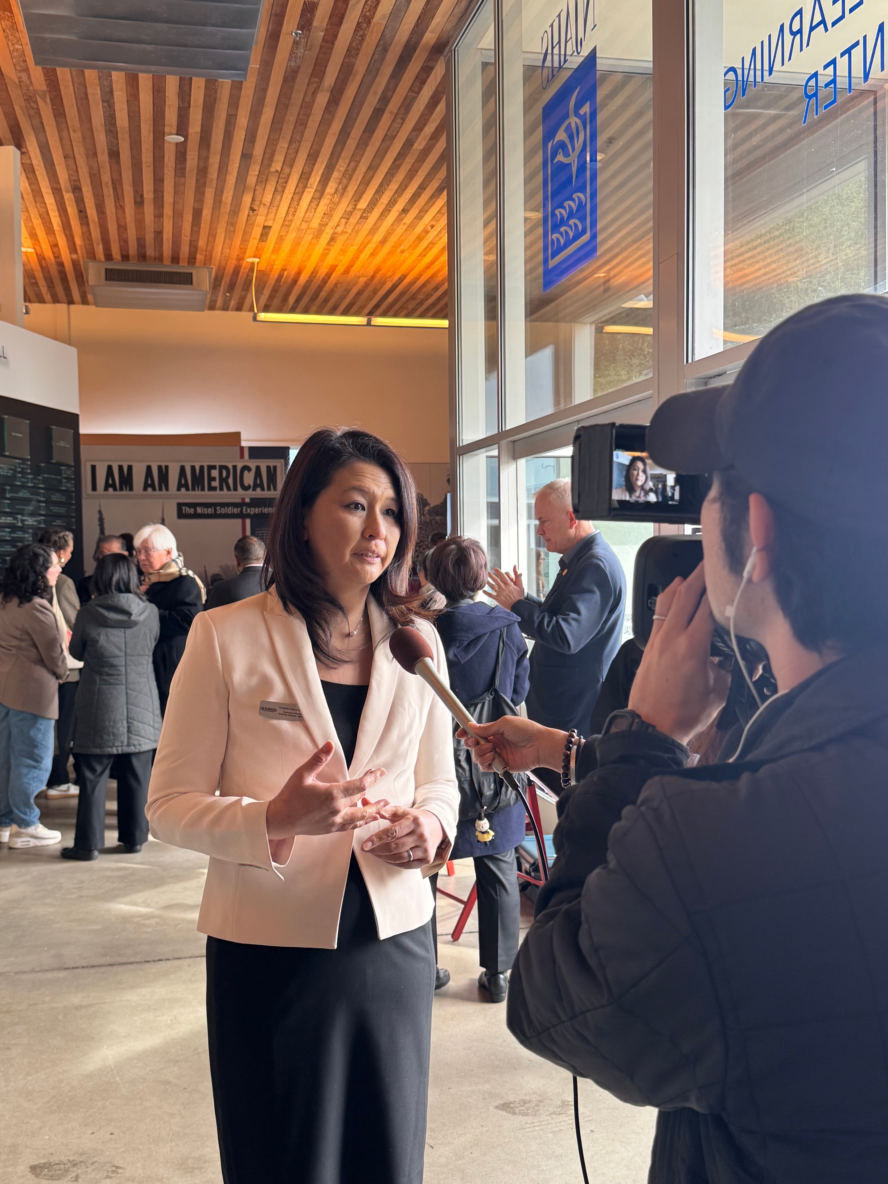 Interview being filmed at a museum-style indoor event