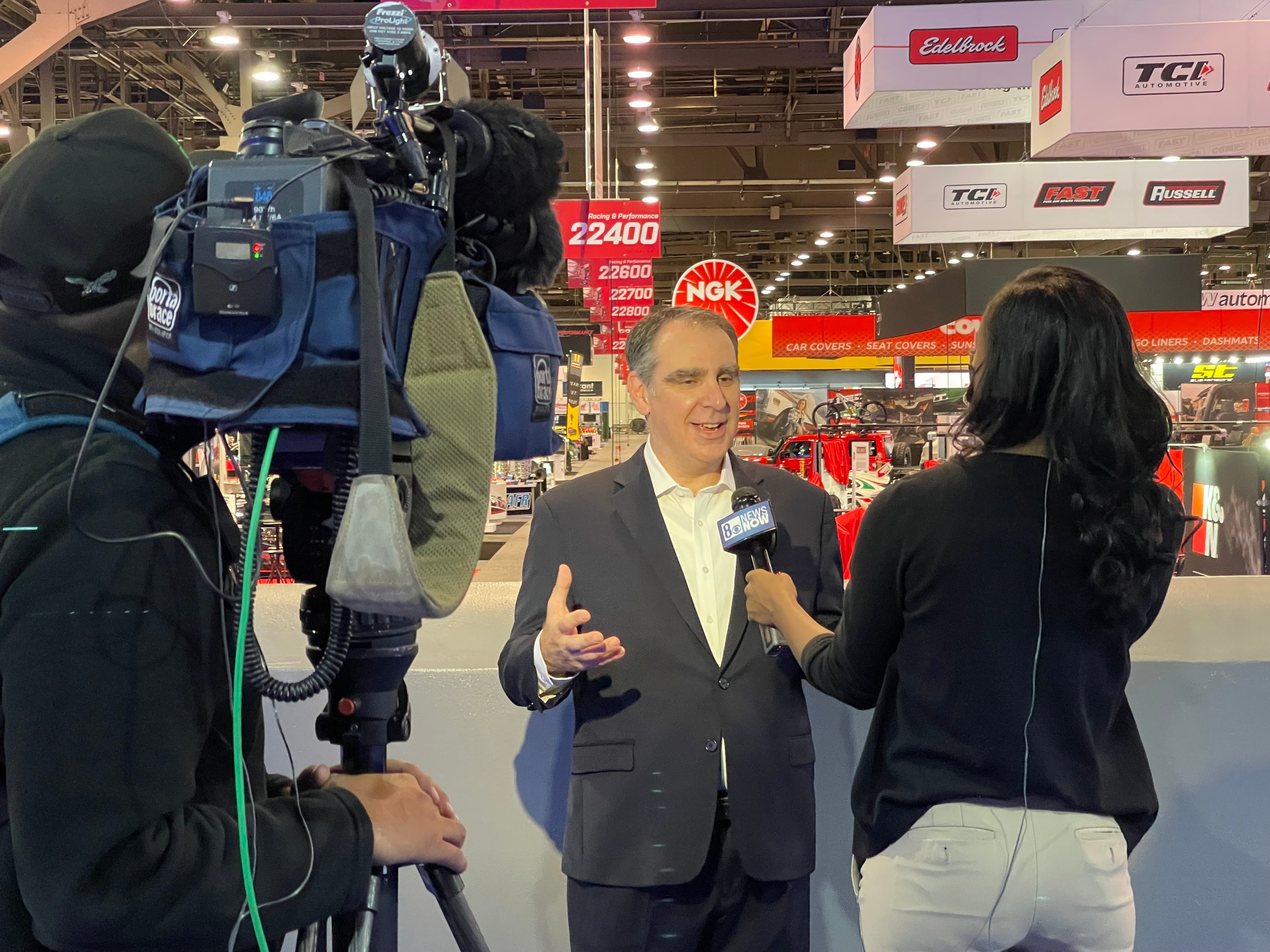 TV news crew filming an interview at SEMA