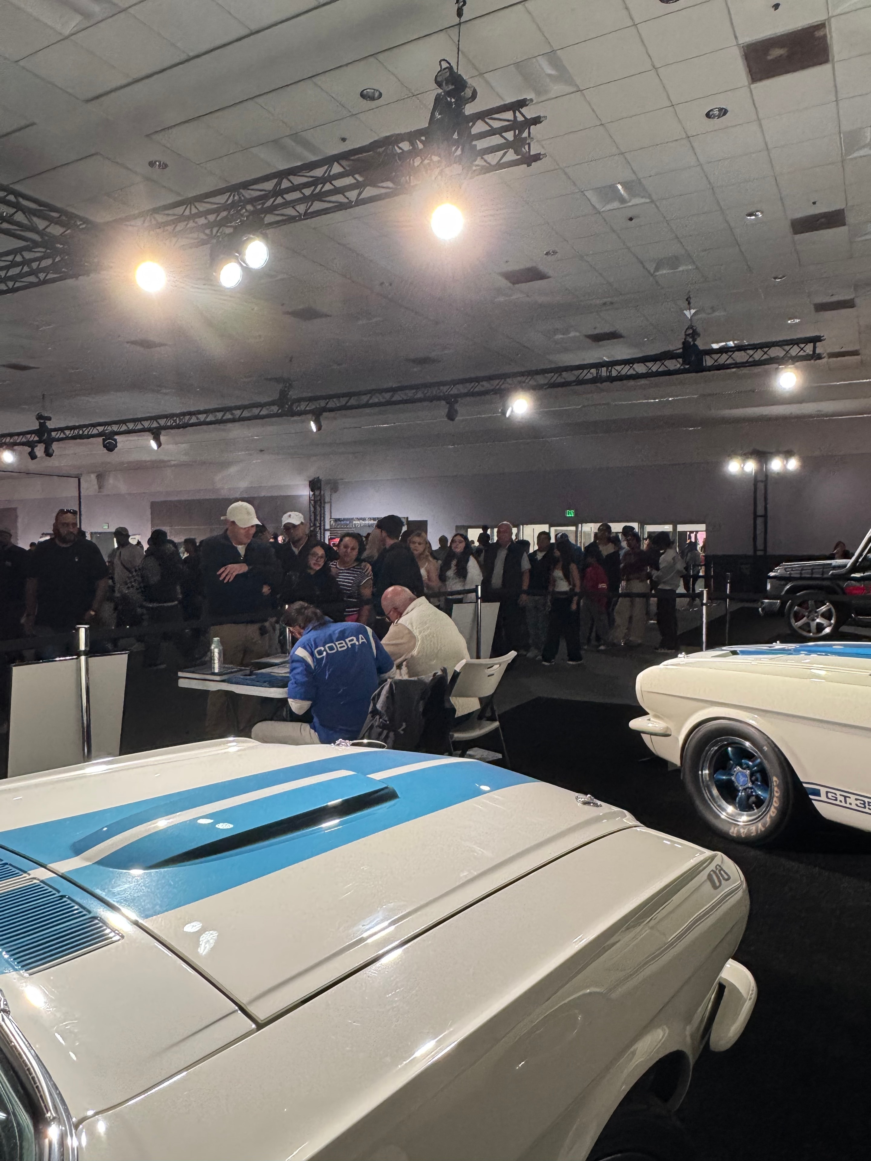 Classic Cobra cars on display at indoor automotive event