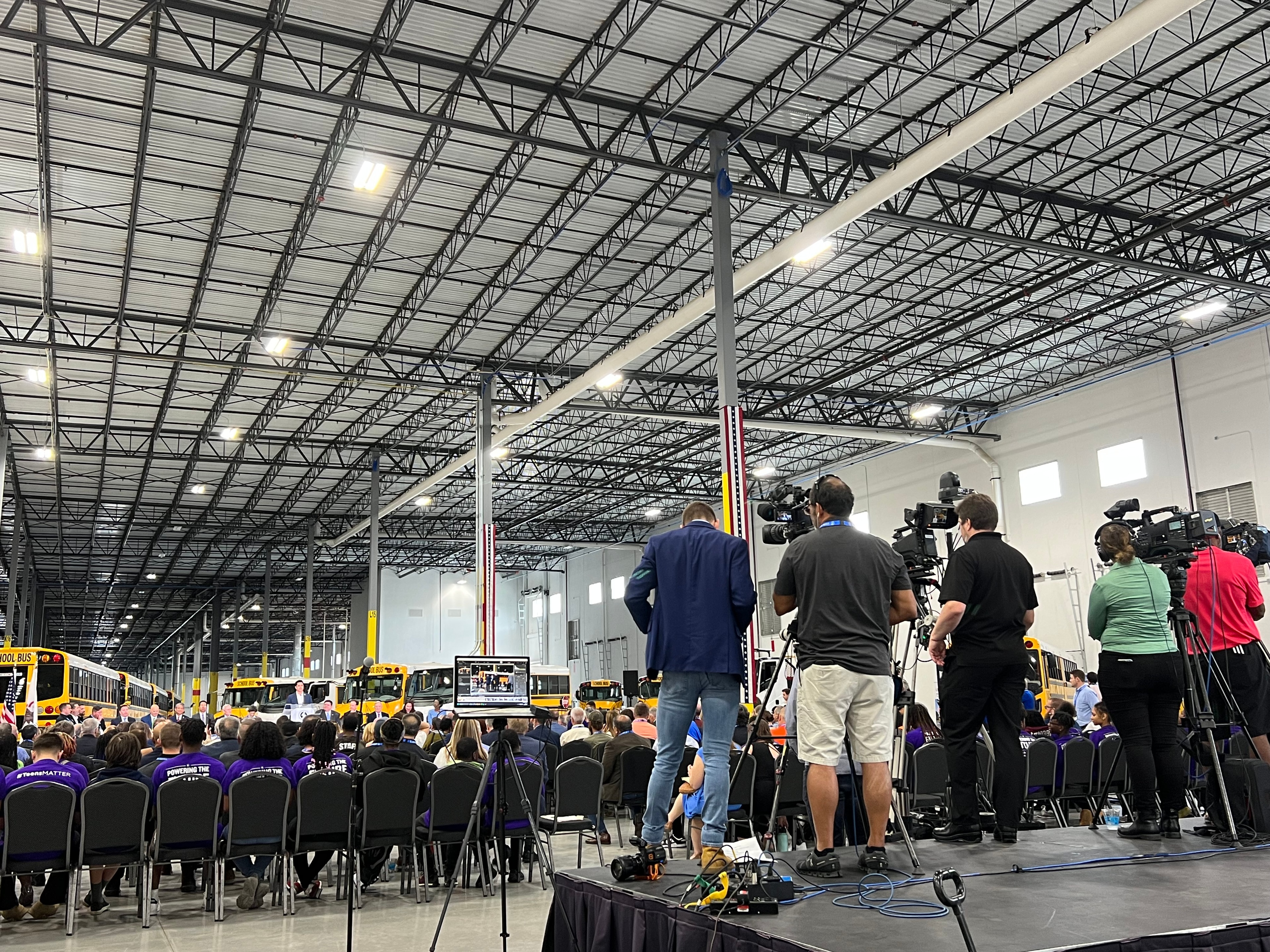 Press event with media crews and large audience